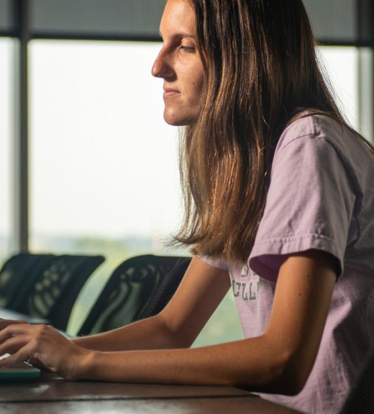 York College student in front of computer.