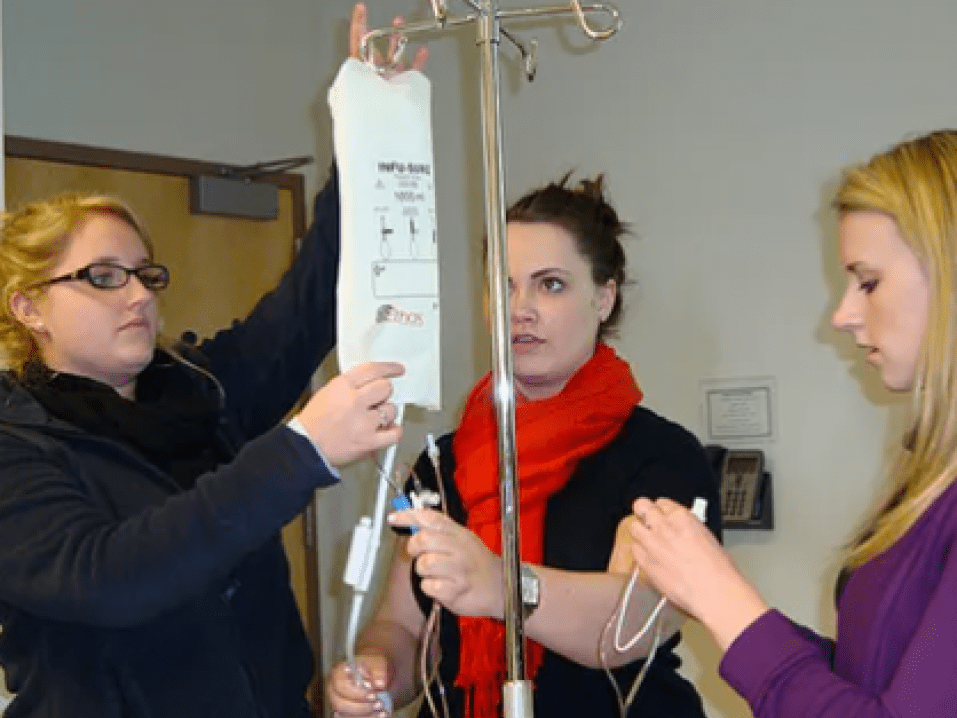 3 students giving an IV drip.