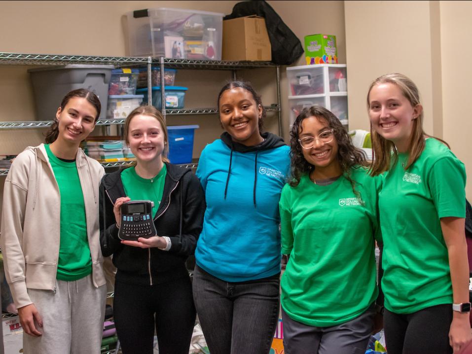 A group of Spartan volunteers helping clean out a local theatre.