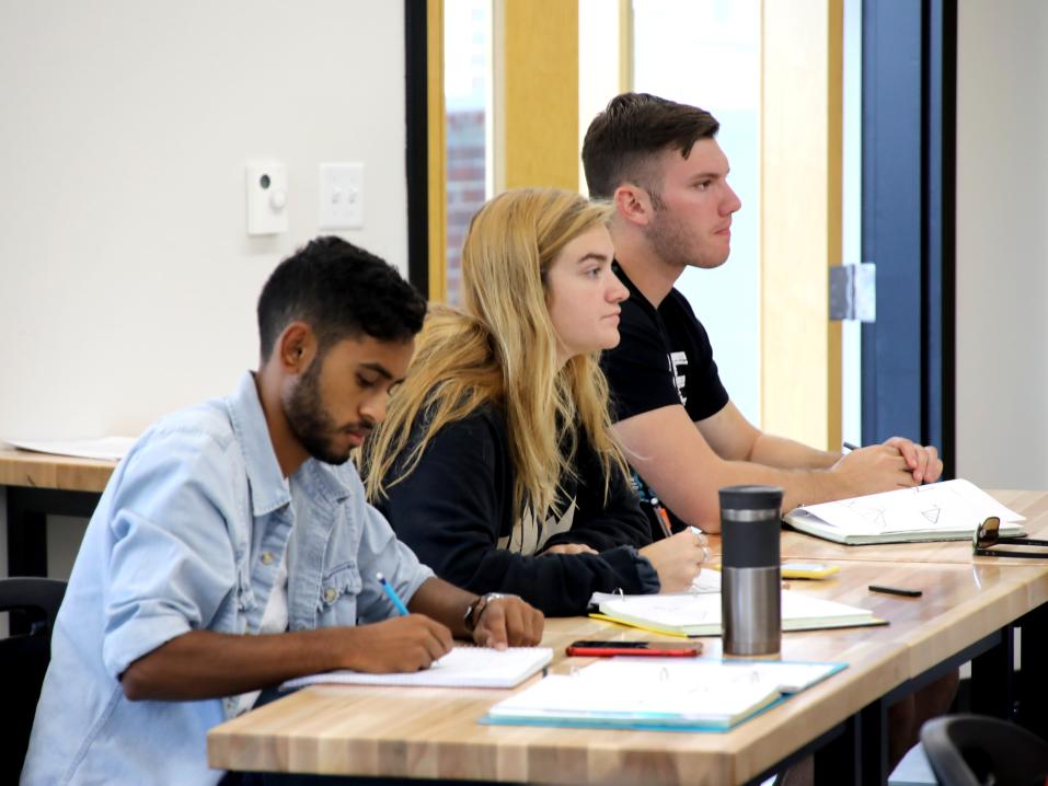 Engineering students are taking notes during class