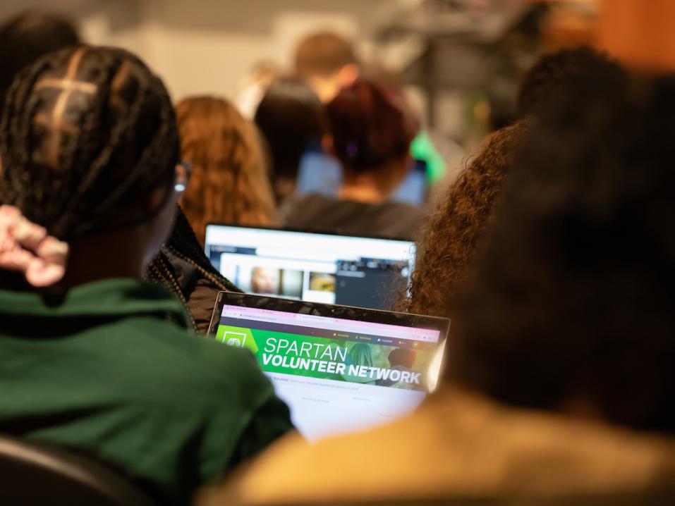 A student looking at the Spartan Volunteer Network webpage.