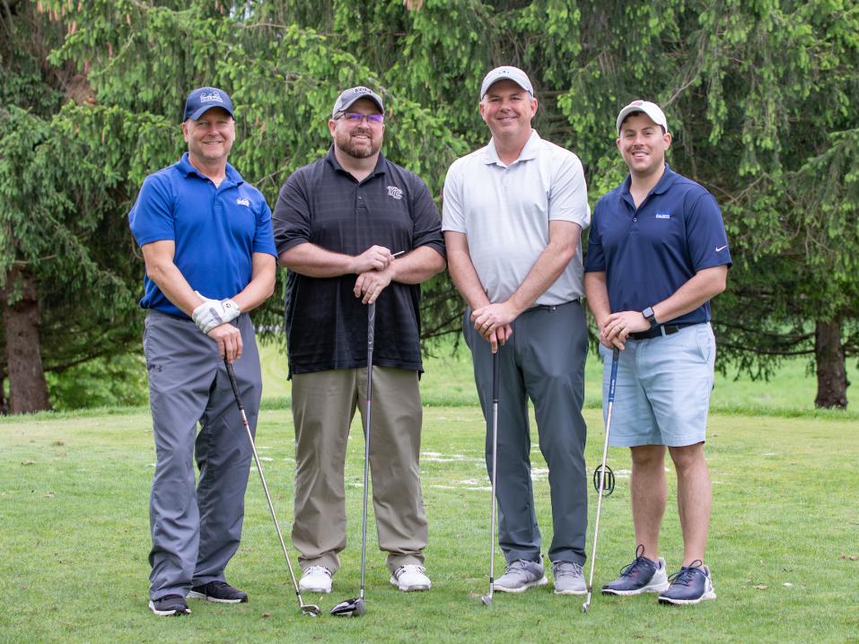 Four golfers at the annual Alumni Golf Outing.