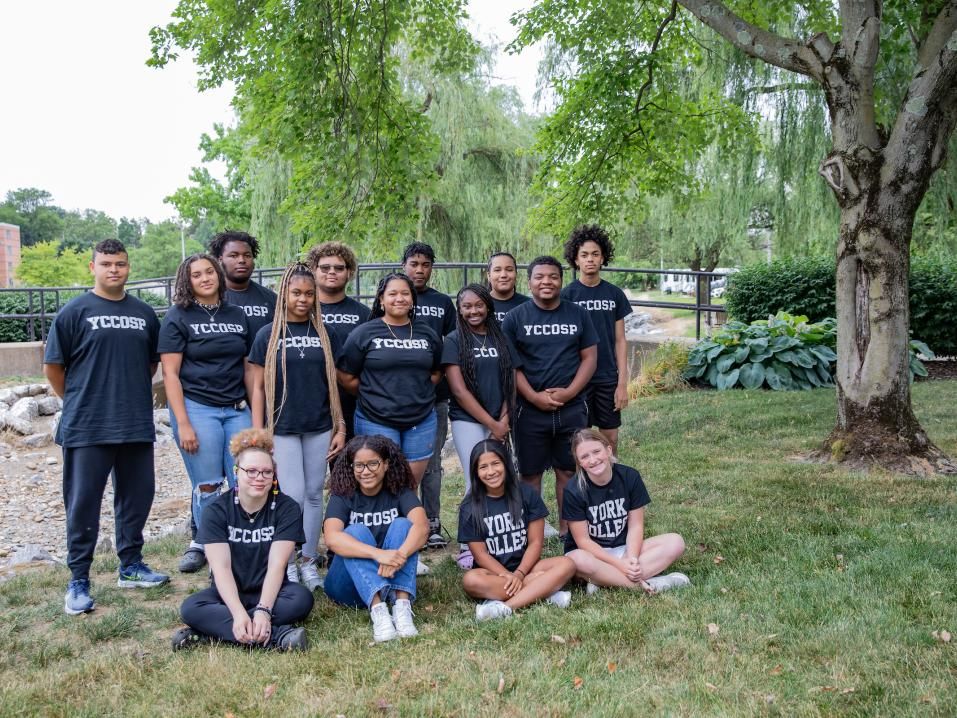 YCCOSP students pose in front of the creek bridge.