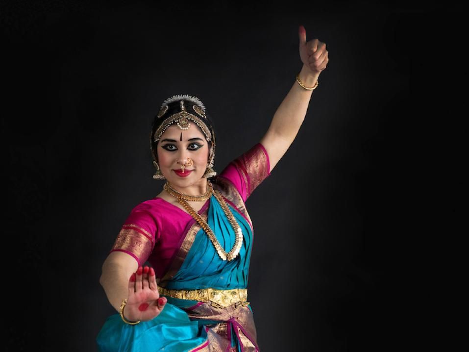 Professional studio photo of Madhavi Reddi in traditional Indian dress, holding a dance pose.