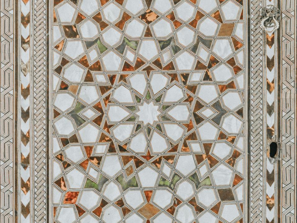 A mosaic of tiles creates a geometric pattern.