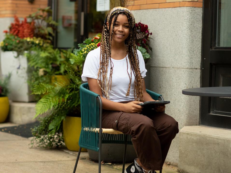 Brianna Simms sits outside at a cafe table