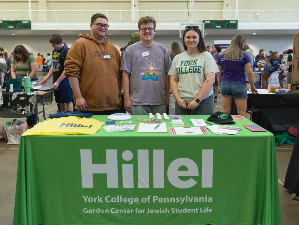 The Hillel group standing with their table at the involvement fair.