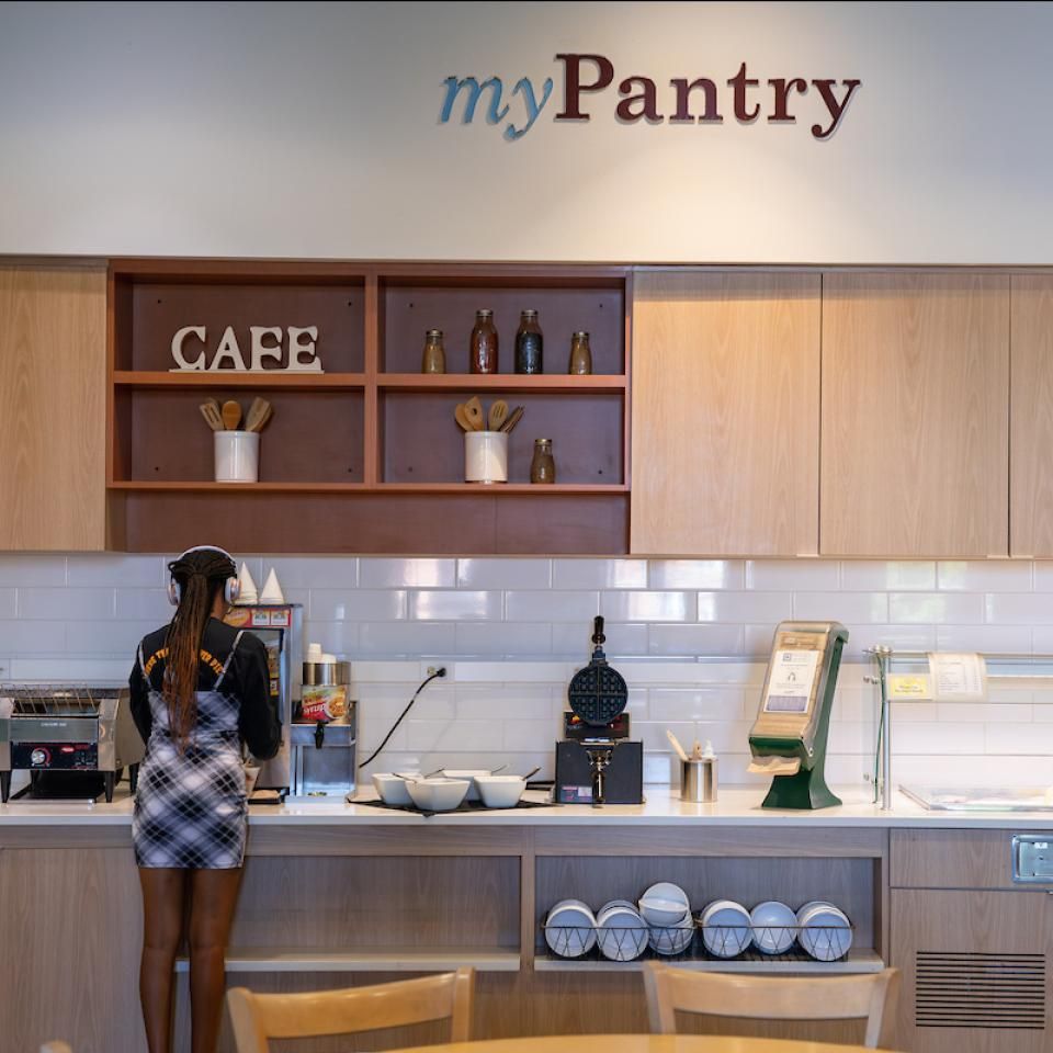 A student stands by the toaster at the My Pantry station in Johnson Dining Hall.