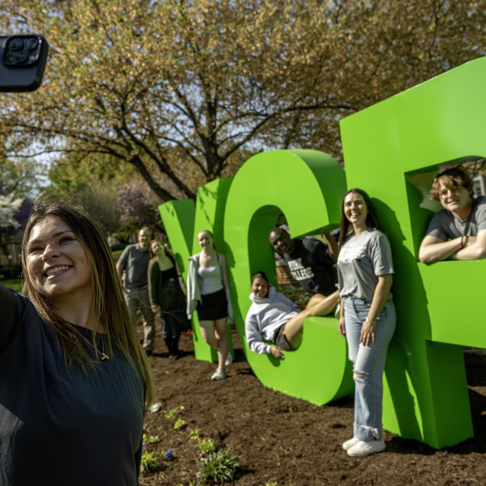 A group of students pose at the YCP sign