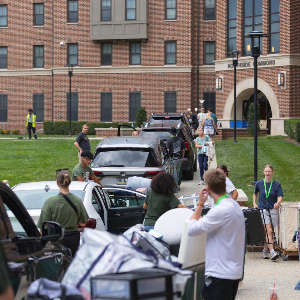 A line of cars outside Northside Commons with people unloading.