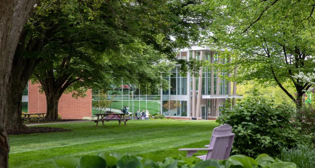 Students walking in front of WPAC on a spring day.