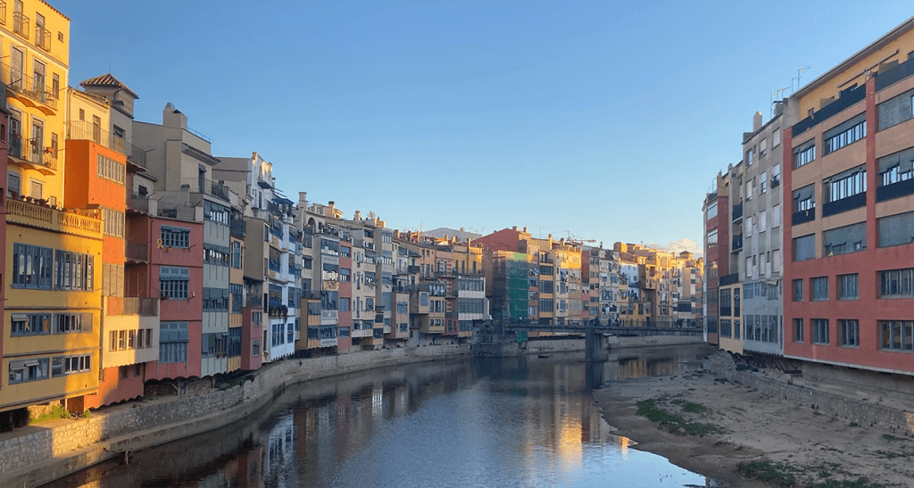 The canals of Venice run through an area with multistory buildings lining the streets.