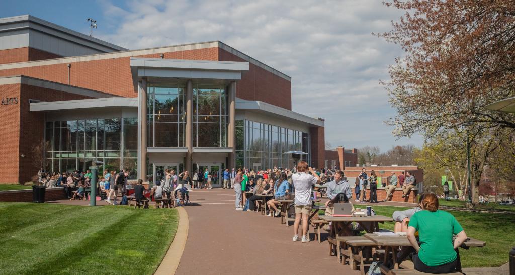 students outside sitting and standing