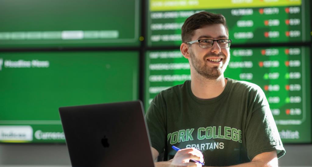 Finance student sitting at a computer.