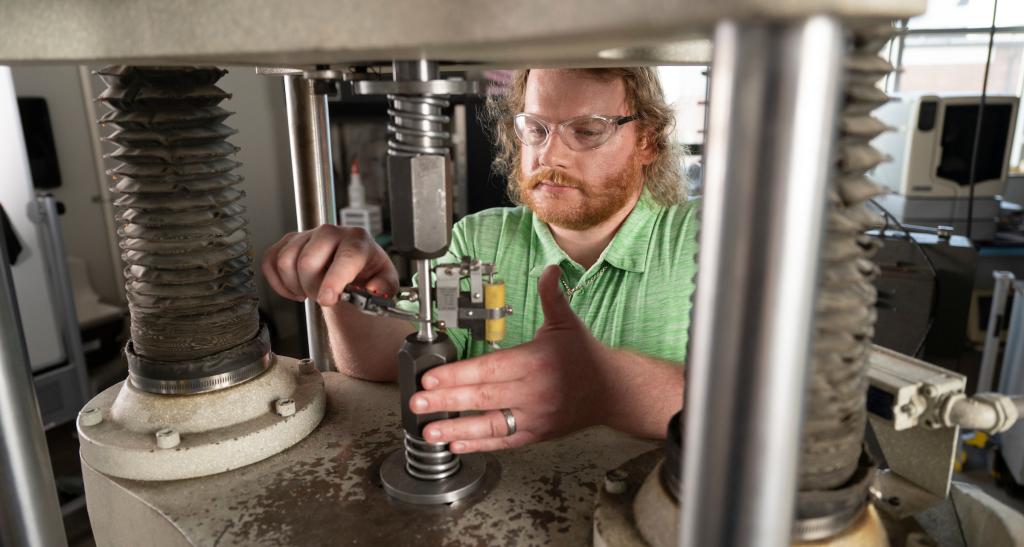 A student works on machinery in the engineering lab.