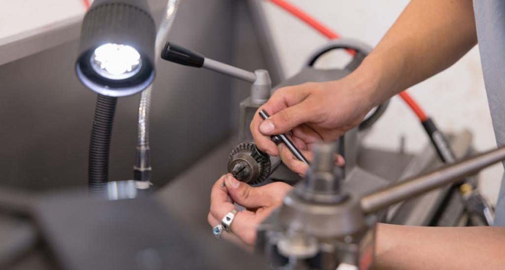 A student works with precision equipment in an engineering workshop.