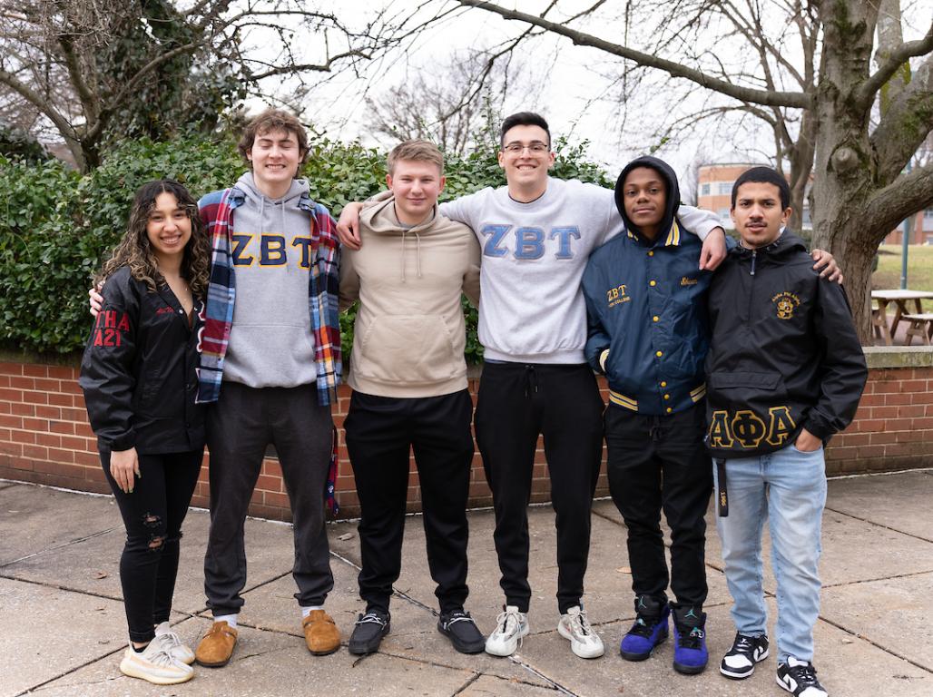 Different fraternity and sorority members pose for a picture