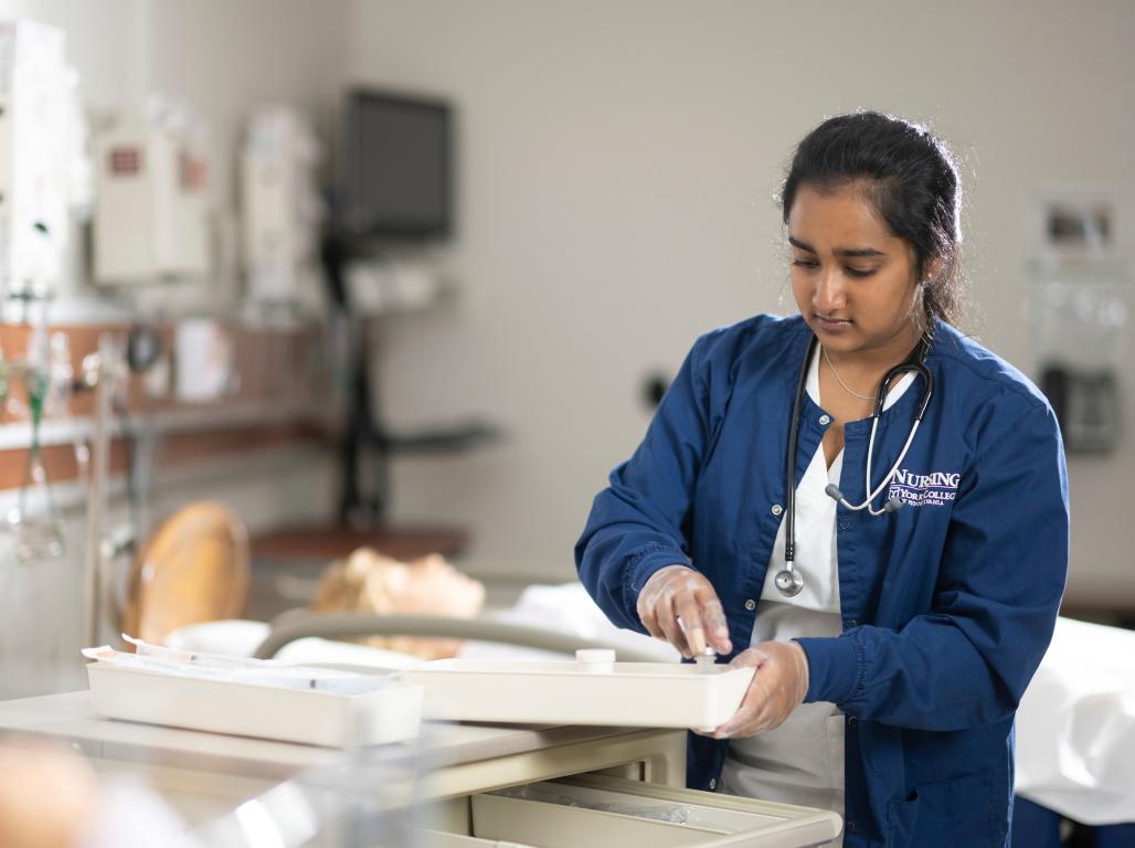 A Nursing student working in the simulation lab.