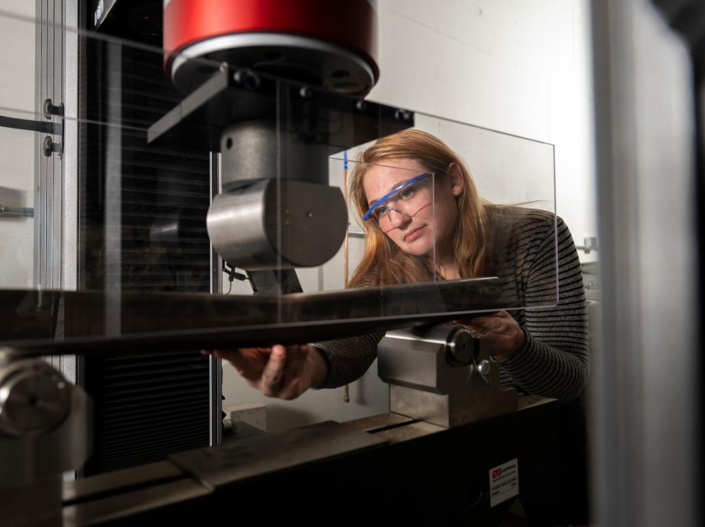 A woman engineer using an engineering tool to create.