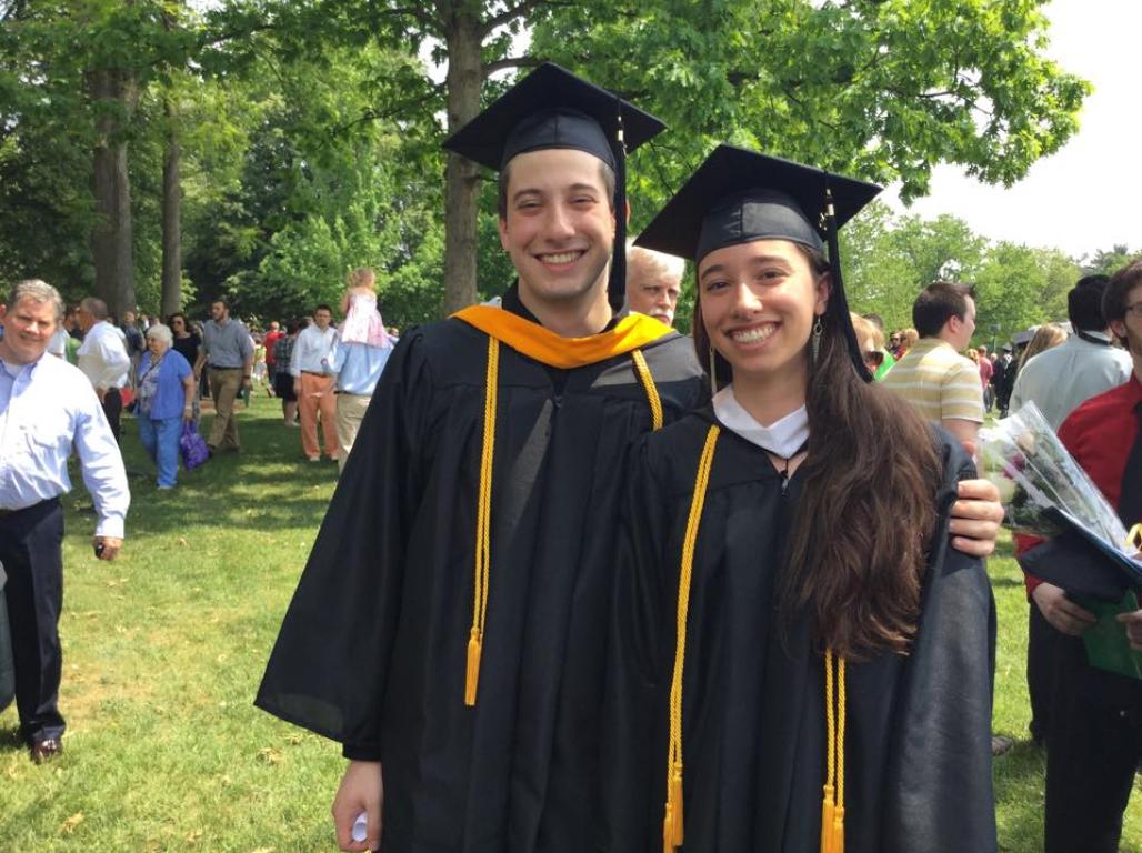 Angela Glotfelter and a friend each in cap and gown on graduation day. 