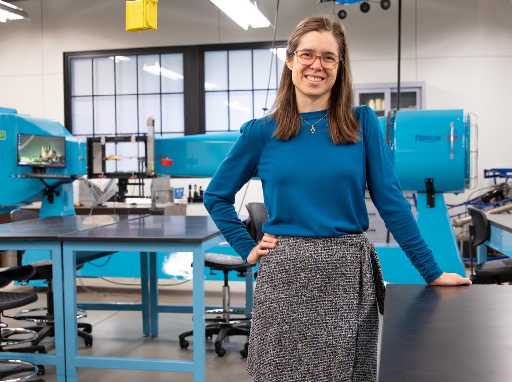 Ashley Earle smiles at the camera in an engineering lab.