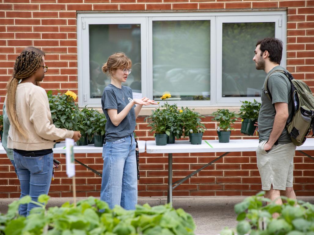 Students purchasing plants at the plant sale by the Environmental Science building on campus.