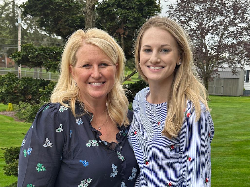 Kim and Jess Cable smile as they pose together for an outdoor photo.