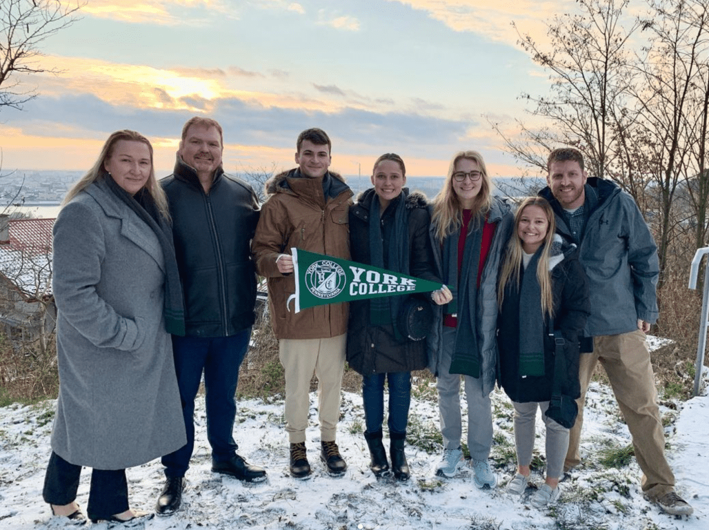 Nursing students in Poland holding a York College flag.