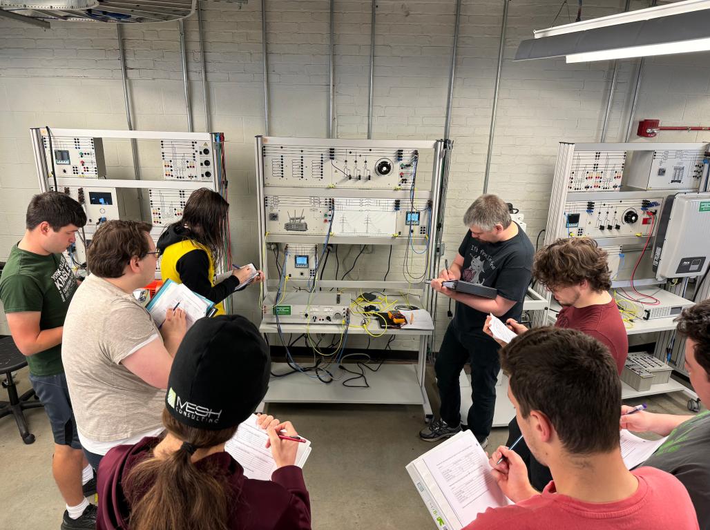 A group of students in the smart power grid laboratory.