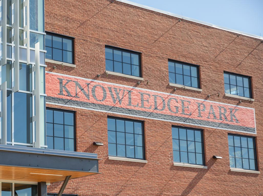 The outside of the new York College Knowledge Park building. The words Knowledge Park are painted on print in black and orange.