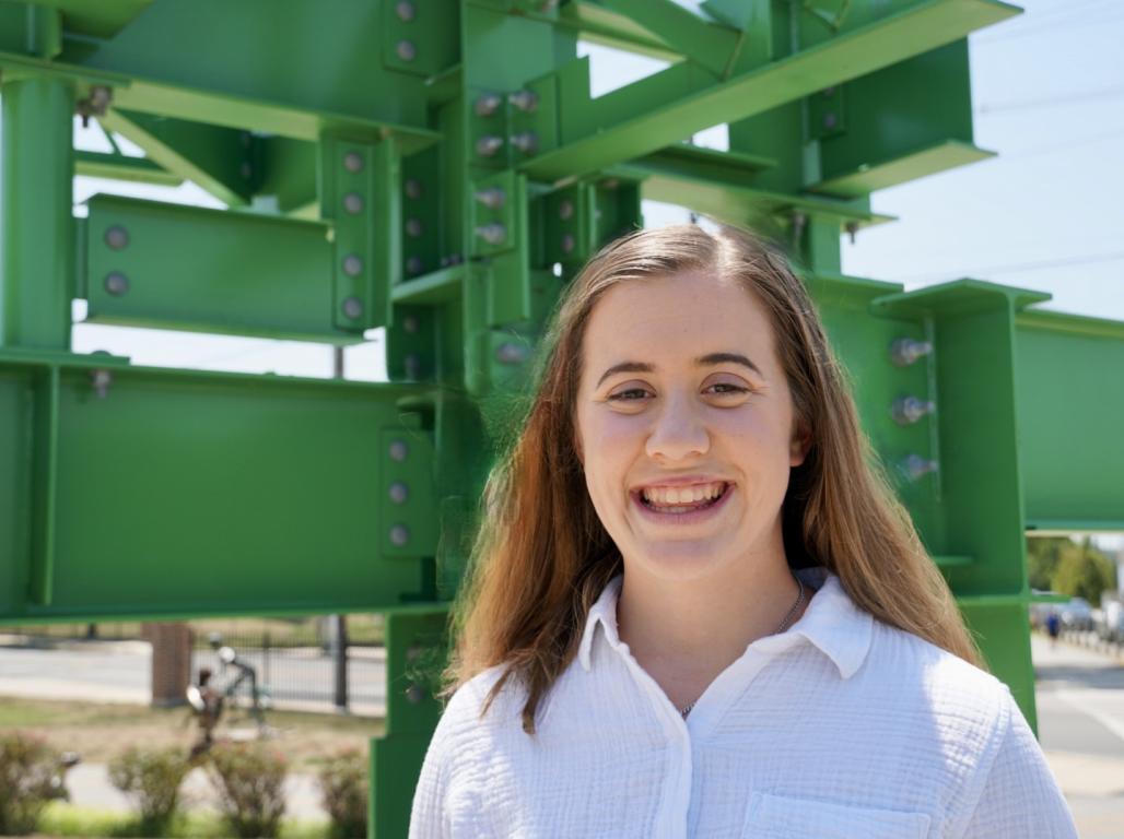 Claire Rumsey poses for a photo beside the Civil Engineering sculpture at York College.