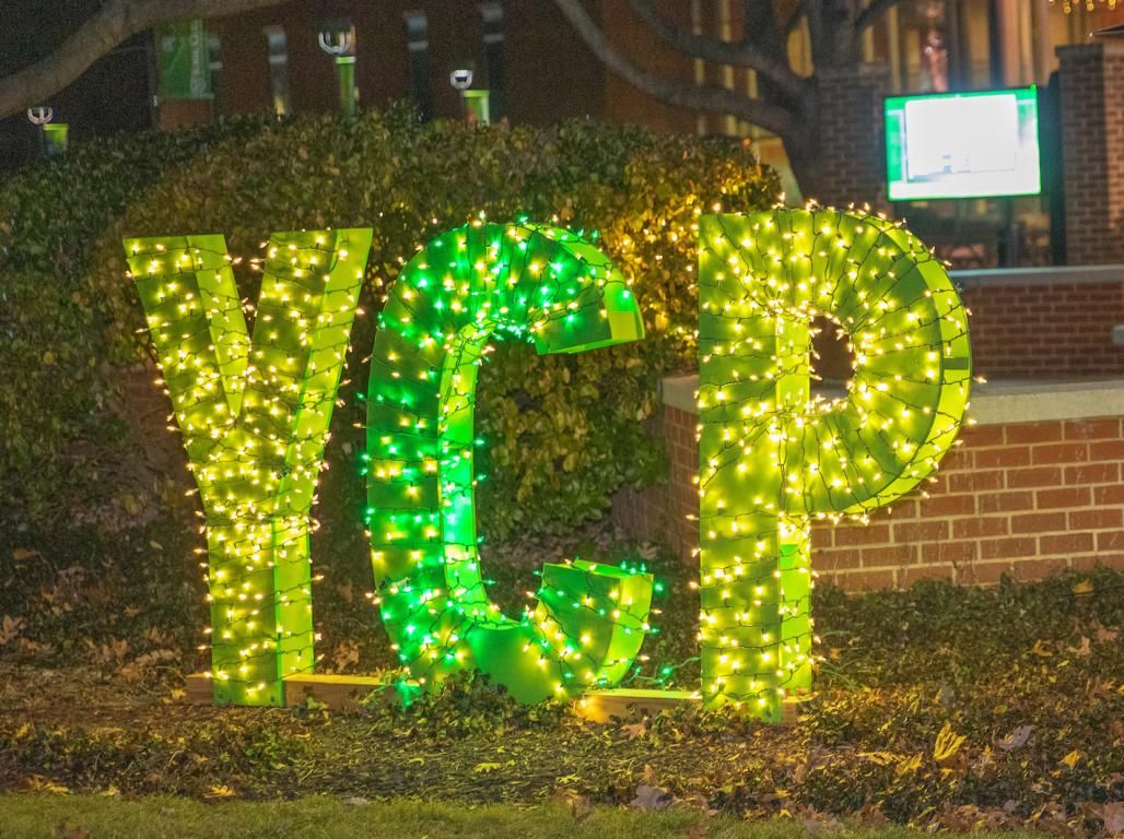 Large green YCP letters decorated in lights to celebrate the holiday season.