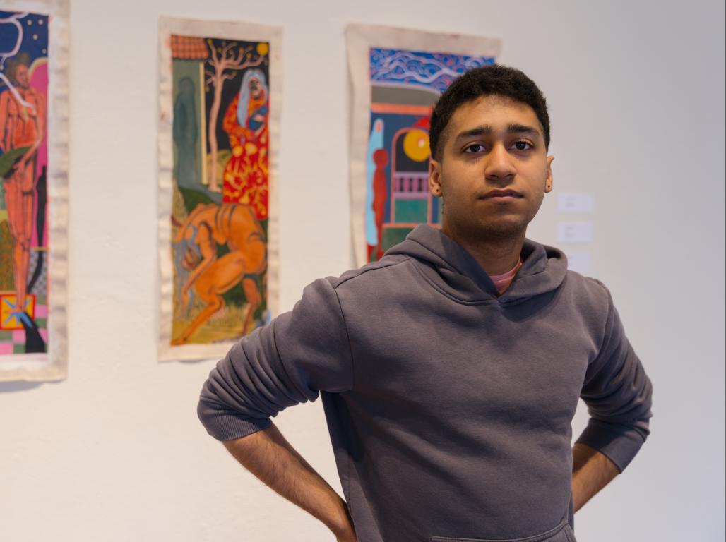 Professional headshot of Gabriel Sanchez Carpio in front of his artwork.
