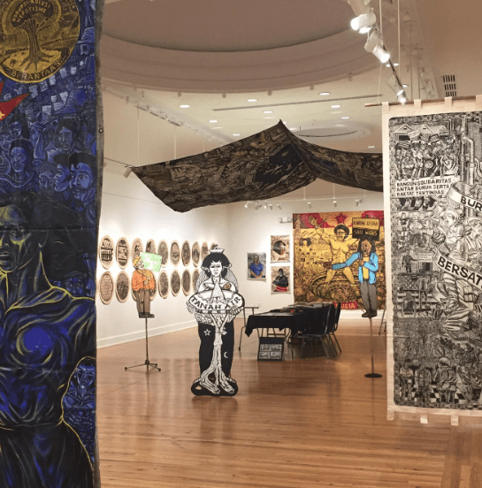 Marketview Arts gallery space featuring large-scale hanging artwork, wall-mounted pieces, and sculptural elements throughout the exhibition room.