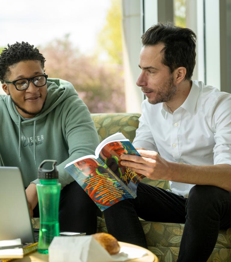 A professor showing the York Review edition to a student.