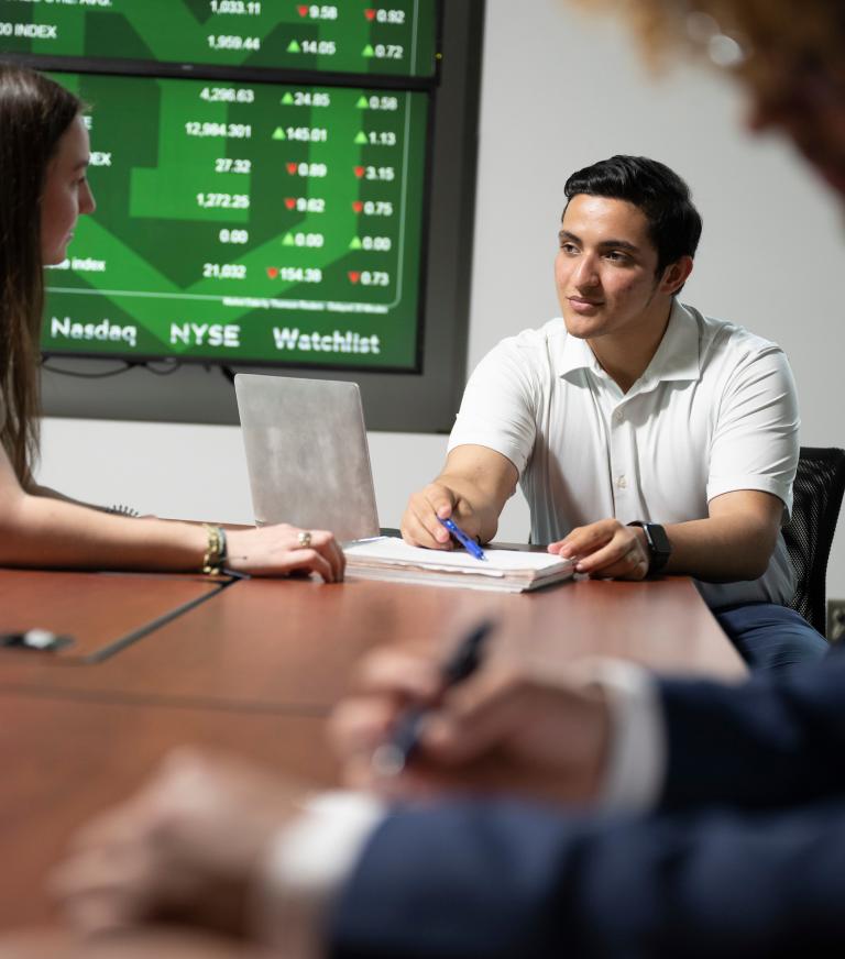 Students collaborate in the NASDAQ Training lab