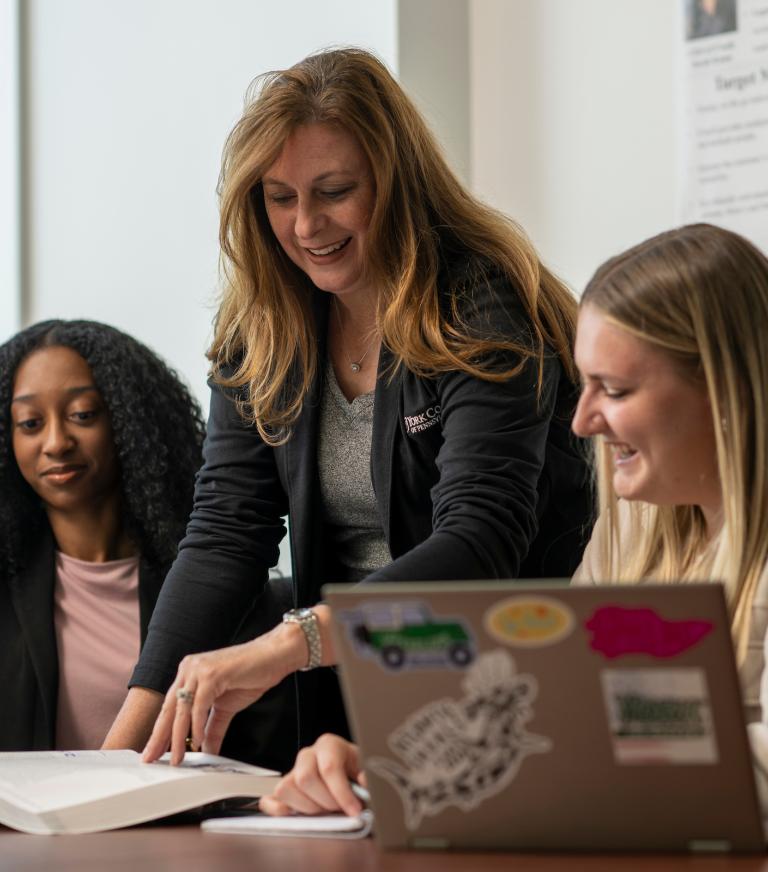 A marketing professor teaching two students.