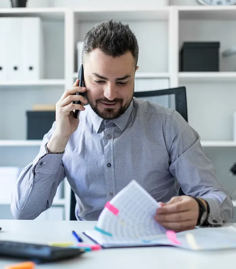 Student on the phone while looking through documents