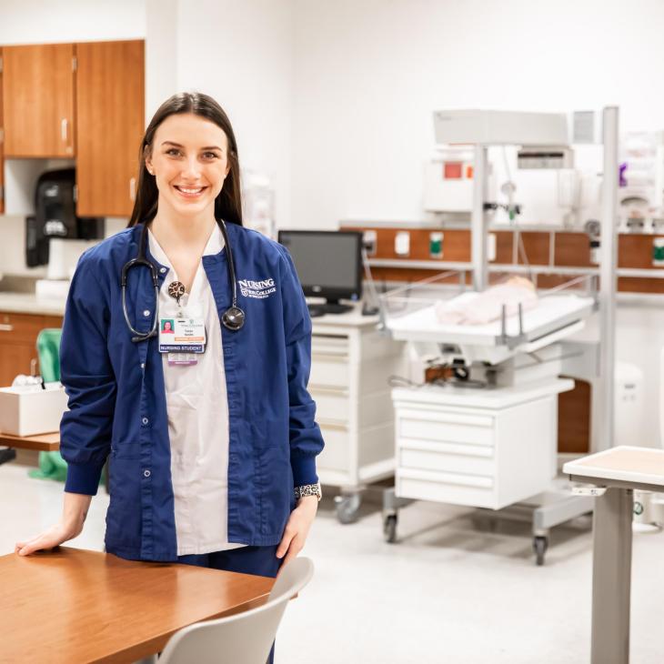 A student in the simulation lab smiling.