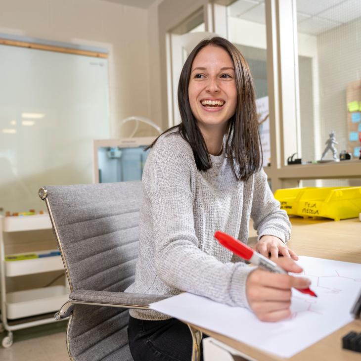 student studying and taking notes in the classroom.