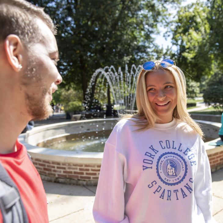 Students hanging out by the fountain