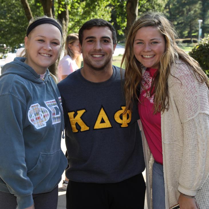 3 Greek Life students smiling.