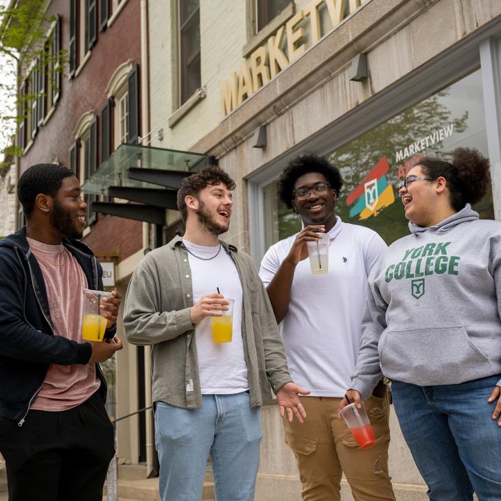 A group of students outside of Marketview Arts.