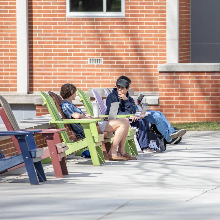 two students sitting and talking