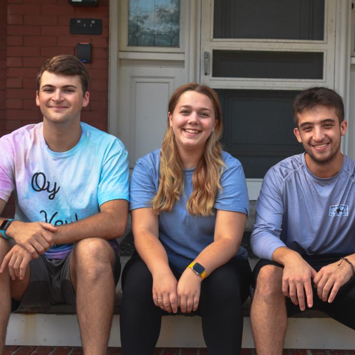 Students sitting on the steps of the Doris and Bernard Center for Jewish Student Life