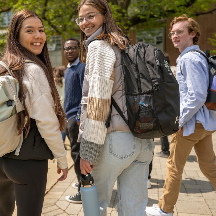 Several students with backpacks walking to class.