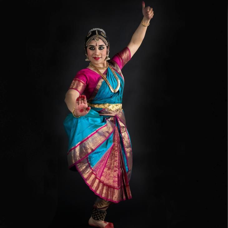 Professional studio photo of Madhavi Reddi in traditional Indian dress, holding a dance pose.