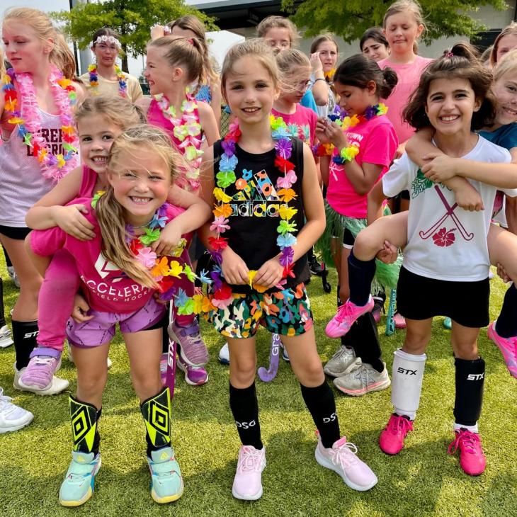 Girls pose for a picture after playing field hockey.