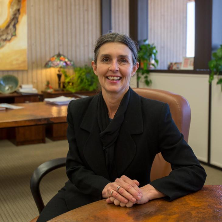 Rebecca Day Babcock sitting in a chair in a professional photo.