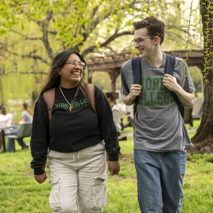 Two students walking together near the creek at YCP.